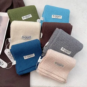 Knitted 100% acrylic scarves in seven solid colors with a textured ribbed pattern