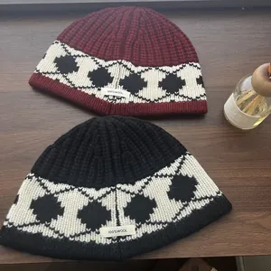 Detail view of 100% wool knit hat showing thick texture and Nordic geometric pattern