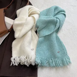 Winter wool blend knit scarf with tassels in creamy white and soft blue colors
