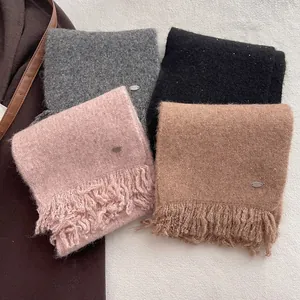 Winter wool blend knit scarves with fringe and sequins in four colors on a flat lay