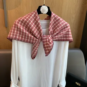 Detail view of the red and white checkered scarf with high quality overlock stitching edge