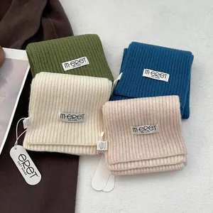 Premium 100% Australian wool knitted scarves in multiple colors with ribbed texture and labels