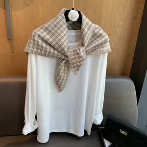 Vintage brown plaid knitted triangle scarf styled with a white long-sleeve top
