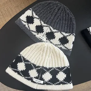 Detailed close-up showing the 100% wool label and retro diamond knit pattern on the warm hat