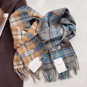 Classic British plaid wool scarves in camel and grey with elegant fringe detailing