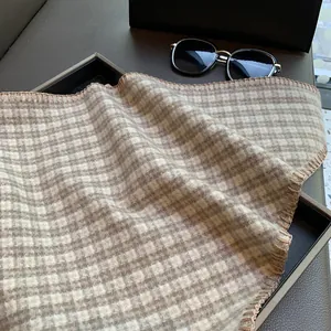 Detail of vintage beige and brown plaid triangle scarf with thick hand-stitched edges