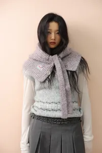 Close-up of purple knit balaclava scarf featuring white button and brand logo label