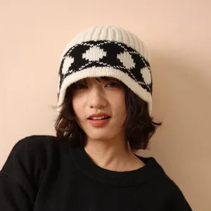 Retro Nordic knit 100% wool bucket hat featuring black heart patterns on creamy white wool