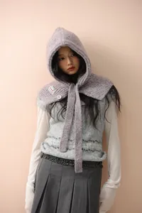 Detail of purple knitted balaclava with button and Bonjour label for winter outfit