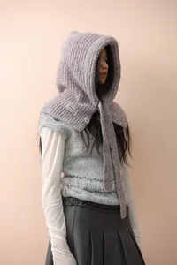 Detail of light purple knitted balaclava showing chunky rib texture and button accent
