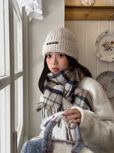 Detailed view of British plaid wool scarf with fringes and beige daily keep going beanie
