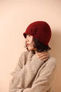 Detail of dark red crochet beanie with 3D floral accent and fine hand-knitted pattern