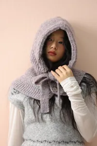 Close-up of purple mixed-knit balaclava with button closure and chunky hood texture