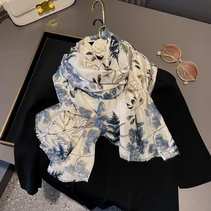 Linen blend long scarf with blue mountain print and gold leaf detail on hanger
