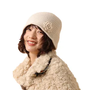 Chic beige handmade crochet flower knit beanie hat worn by a model in a studio setting