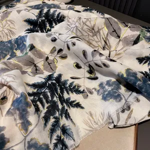 Beige cotton linen scarf with blue botanical leaf prints and elegant gold foil details