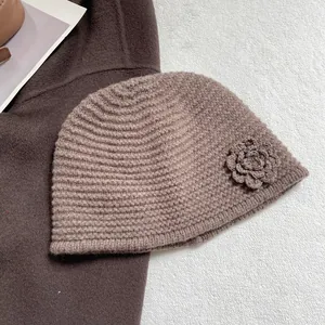 Detailed texture of brown crochet knit beanie with side flower accent and soft wool finish