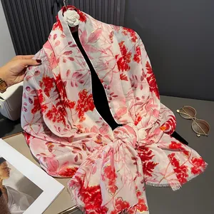 Detail of floral linen scarf with gold foil accents and delicate frayed edge finish