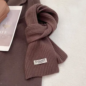 Close-up of deep brown 100% Australian wool scarf showing thick ribbed knit texture
