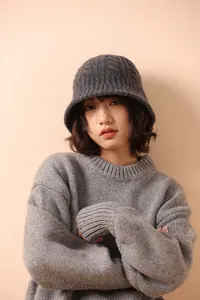 Detail of grey merino wool knit bucket hat featuring a textured ribbed weave and casual style
