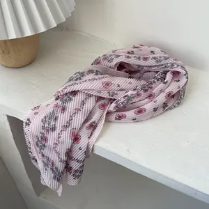 Detail of pleated floral chiffon scarf in pink with elegant micro-crinkle texture