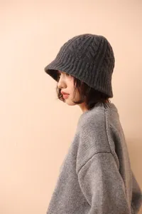 Detail of dark grey merino wool fisherman hat featuring premium thick cable knit texture