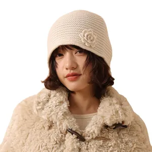 Women's cream knitted beanie hat with rose flower detail for autumn and winter wear