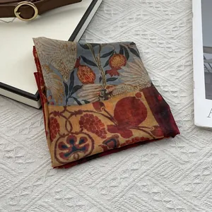 Ethnic style colorful floral silk cotton square scarf with vintage pattern on white carpet