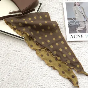Elegant cotton triangle scarf with geometric cross pattern in brown and yellow tones