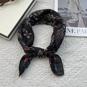 Detailed view of tied black paisley cotton linen scarf with vintage bohemian floral pattern