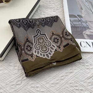 Detail of vintage paisley cotton linen scarf with elegant floral patterns and soft texture