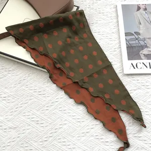 Macro shot of double-sided cotton scarf with geometric pattern and wavy stitched edge