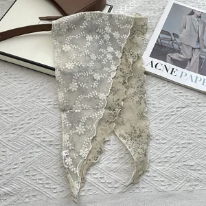 Detail of floral linen neck scarf showing intricate white lace embroidery and double-layer fabric