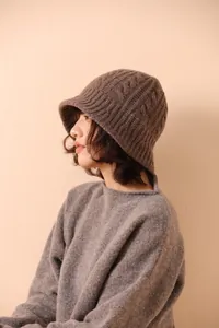 Detail of dark brown cable knit texture on a premium Merino wool fisherman bucket hat