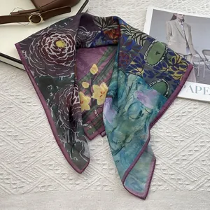 Detailed view of floral silk scarf featuring purple camellia prints and fine edge stitching