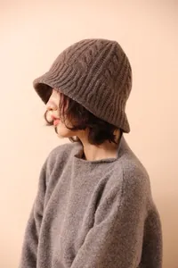 Detailed cable knit texture of dark brown merino wool bucket hat for women