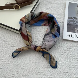 Close-up of artistic color-block silk square scarf with colorful geometric patterns