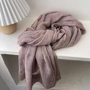 Detail view of pink linen cotton scarf with textured weave and rainbow stitching