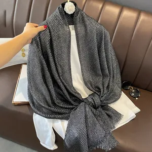 Detail of grey cotton linen scarf with gold foil texture and soft fringe edges