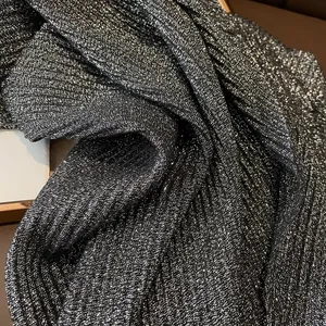 Detail of coffee gold-sprinkled linen scarf with metallic pleated texture and shimmer