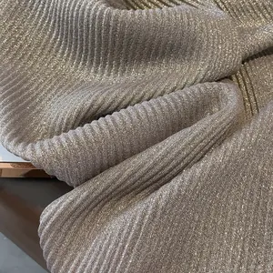 Close-up of gold leaf texture on pleated linen scarf showing shimmering metallic details