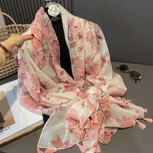 Pink floral cotton linen scarf with bohemian tassels displayed on a mannequin