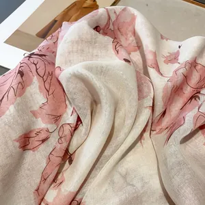 Close-up of pink floral pattern on breathable linen scarf with natural fabric texture