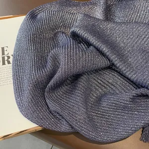 Detailed macro view of navy blue cotton linen scarf with sparkling gold glitter effect