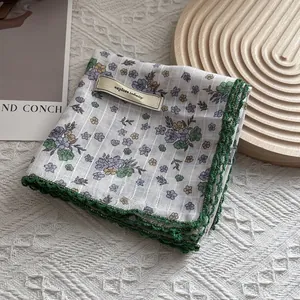 Detail of floral silk scarf with crochet lace edge and explore infinity fabric tag