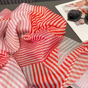 Elegant red and white striped sheer scarf with pleated texture and stylish sunglasses