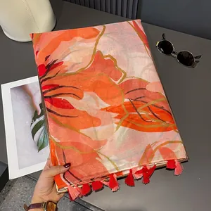 Floral print voile scarf with tropical orange flowers and red fringe tassels for summer
