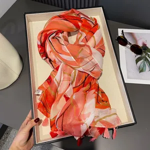 Tropical plant print scarf shawl with orange abstract patterns and tassel detailing