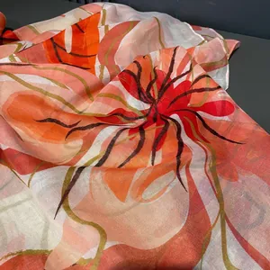 Detail of thin scarf with tropical floral print and lightweight voile texture