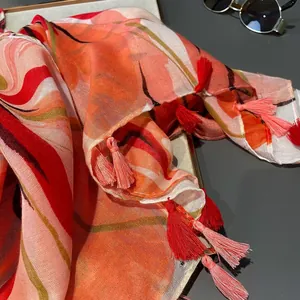 Tropical leaf print voile shawl with red tassels and lightweight breathable fabric